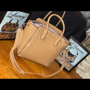 Tote accessorized with gold jewels and rhinestones